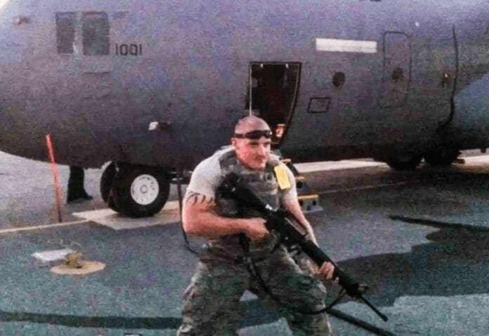 DCD3CE59-5B8E-4A3E-BFFC-A676D8768131 A man with a machine gun.