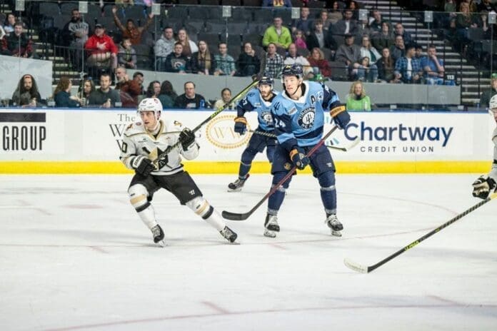 Guys playing hockey.
