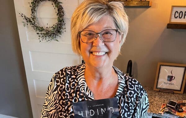 72E527A4-229B-4C2F-A193-2A40A508EF58 A woman holding a book.