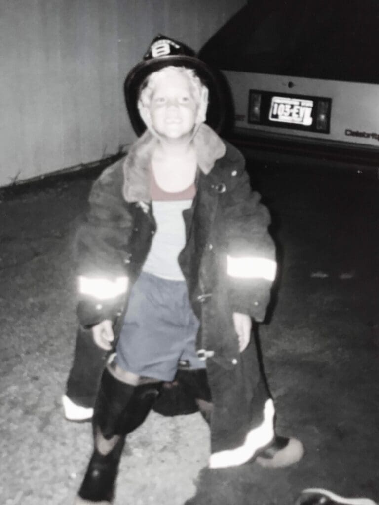 A kid dressed as a firefighter.