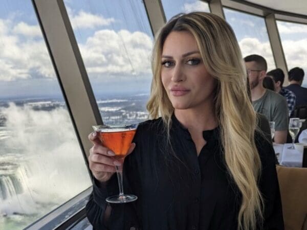 F3E28F47-A49B-40DF-9B67-DC73580D9101 A woman with a drink.