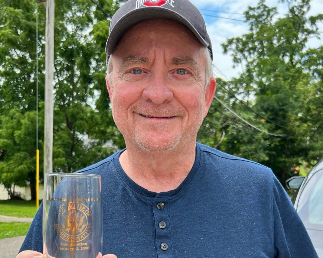 A man holding a glass.