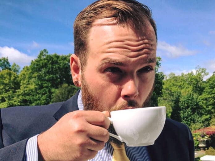 ED3C117B-3992-4BF8-BABC-8B23D60CC22A A man drinking coffee.