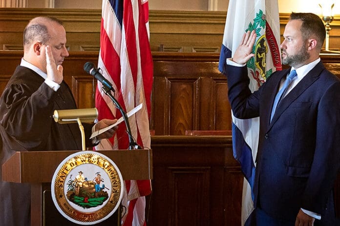 4CCE7EA4-C2BB-4663-83E2-E98A7E0D8F9E A person swearing on The Bible.