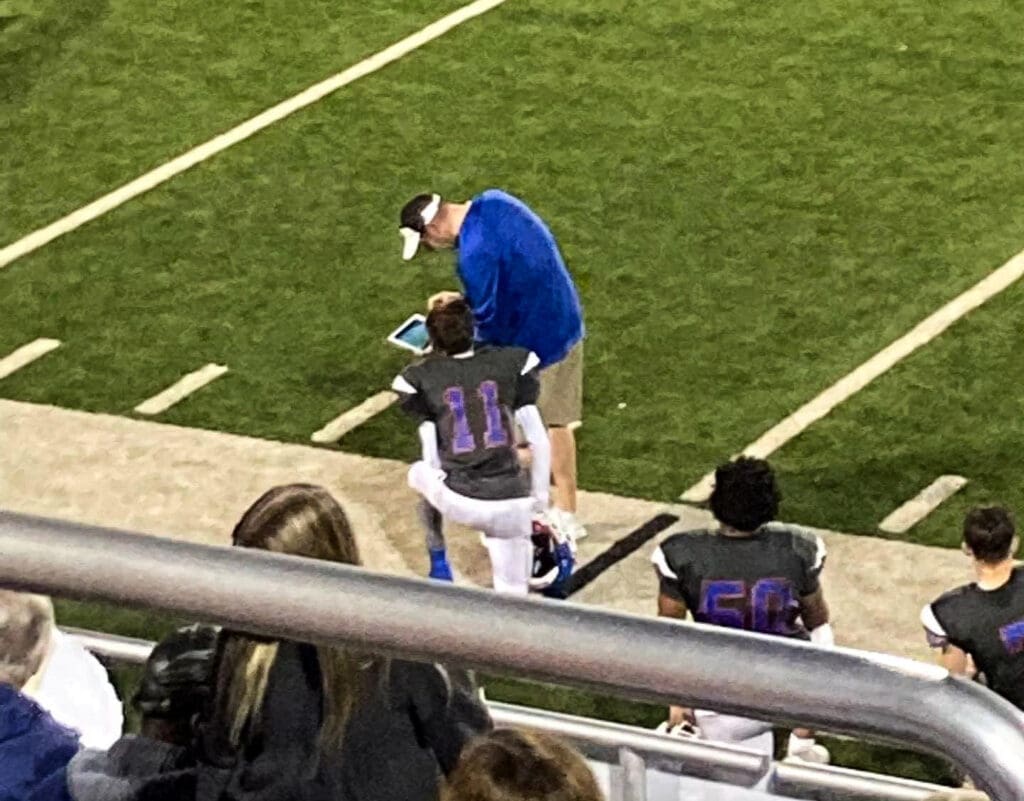 A man coaching a kid.