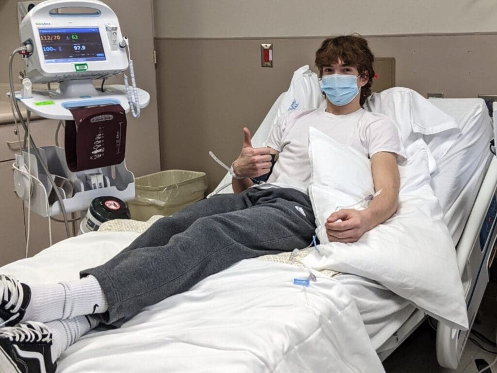 A boy in a hospital bed.