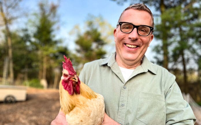 A man with a chicken.