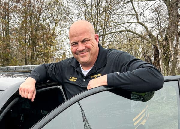 A man leaning on a car.
