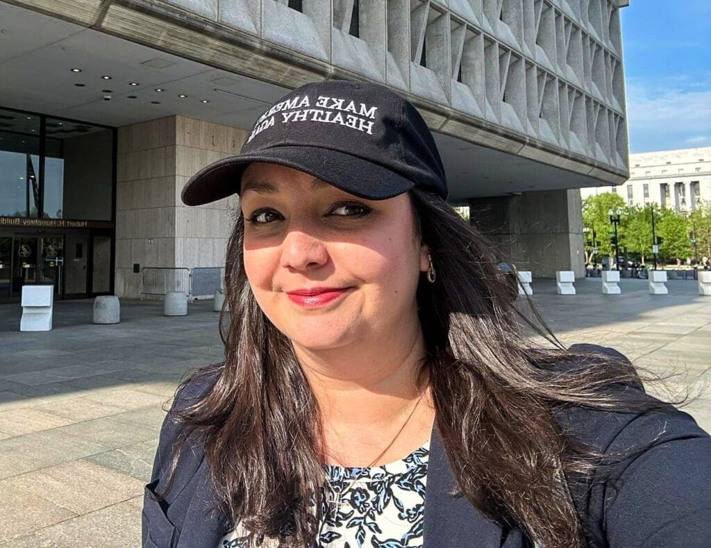 A lady in a ballcap.