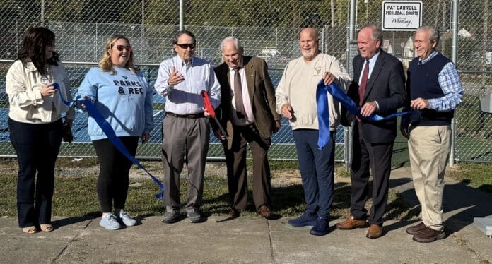 Ribbon Cutting (1) A group of people.