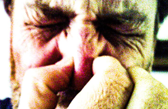 A man holding his nose.